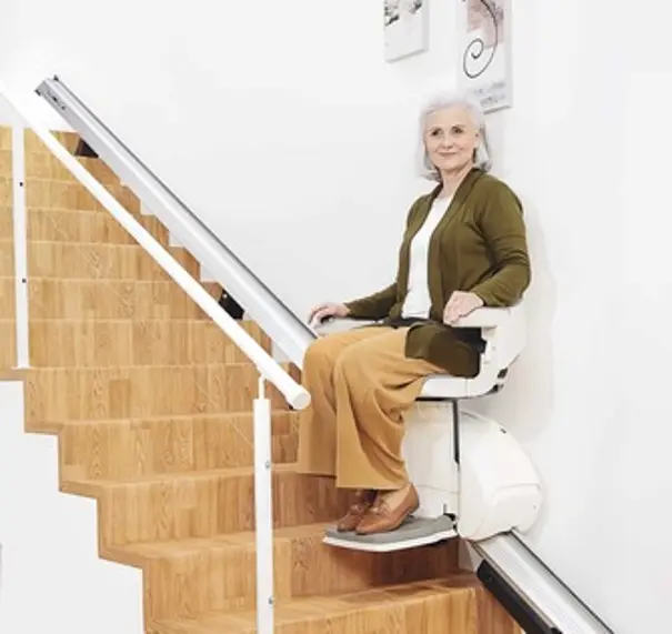 Woman sitting on the straight stairlift 